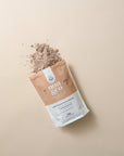 Noa & Co Chocolate Replenishing Protein pouch, with powder pouring out