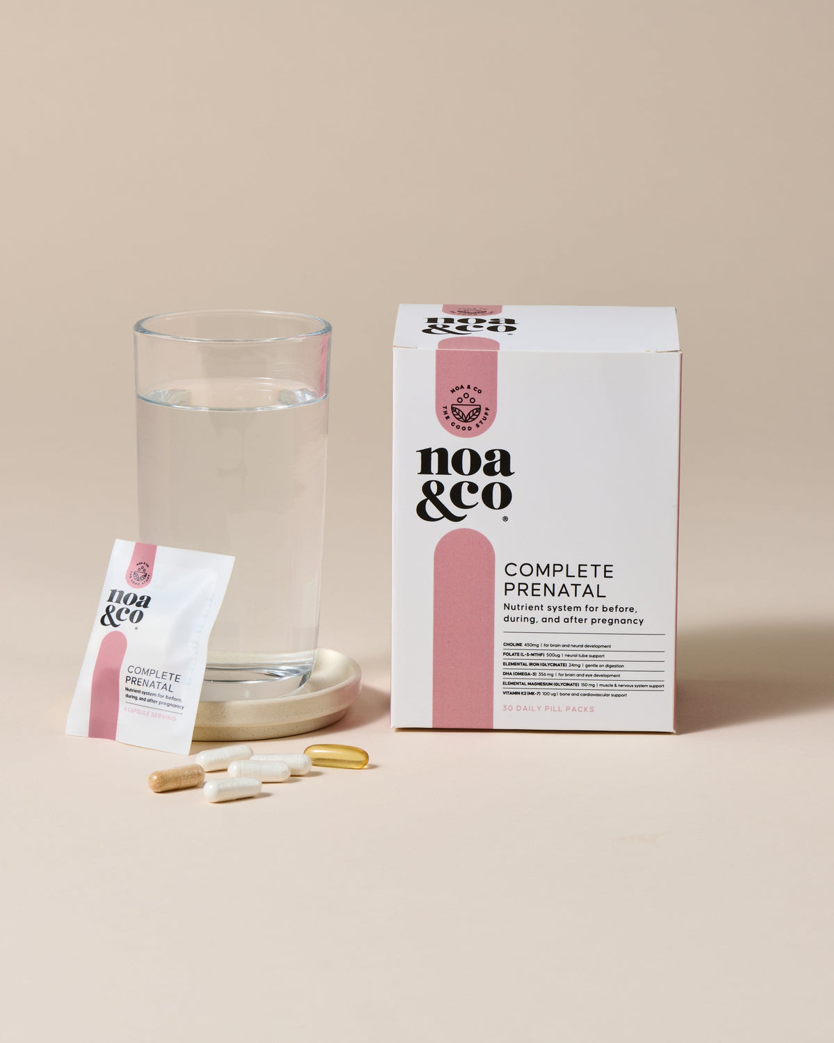Noa &amp; Co Complete Prenatal capsules held in water