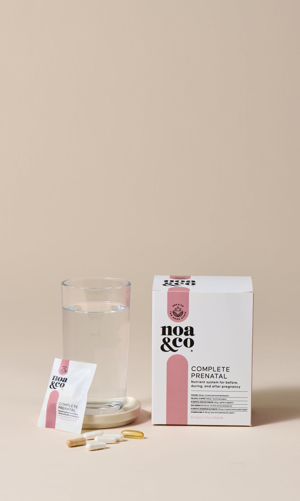 Noa & Co Complete Prenatal box, sachet and capsules beside a glass of water