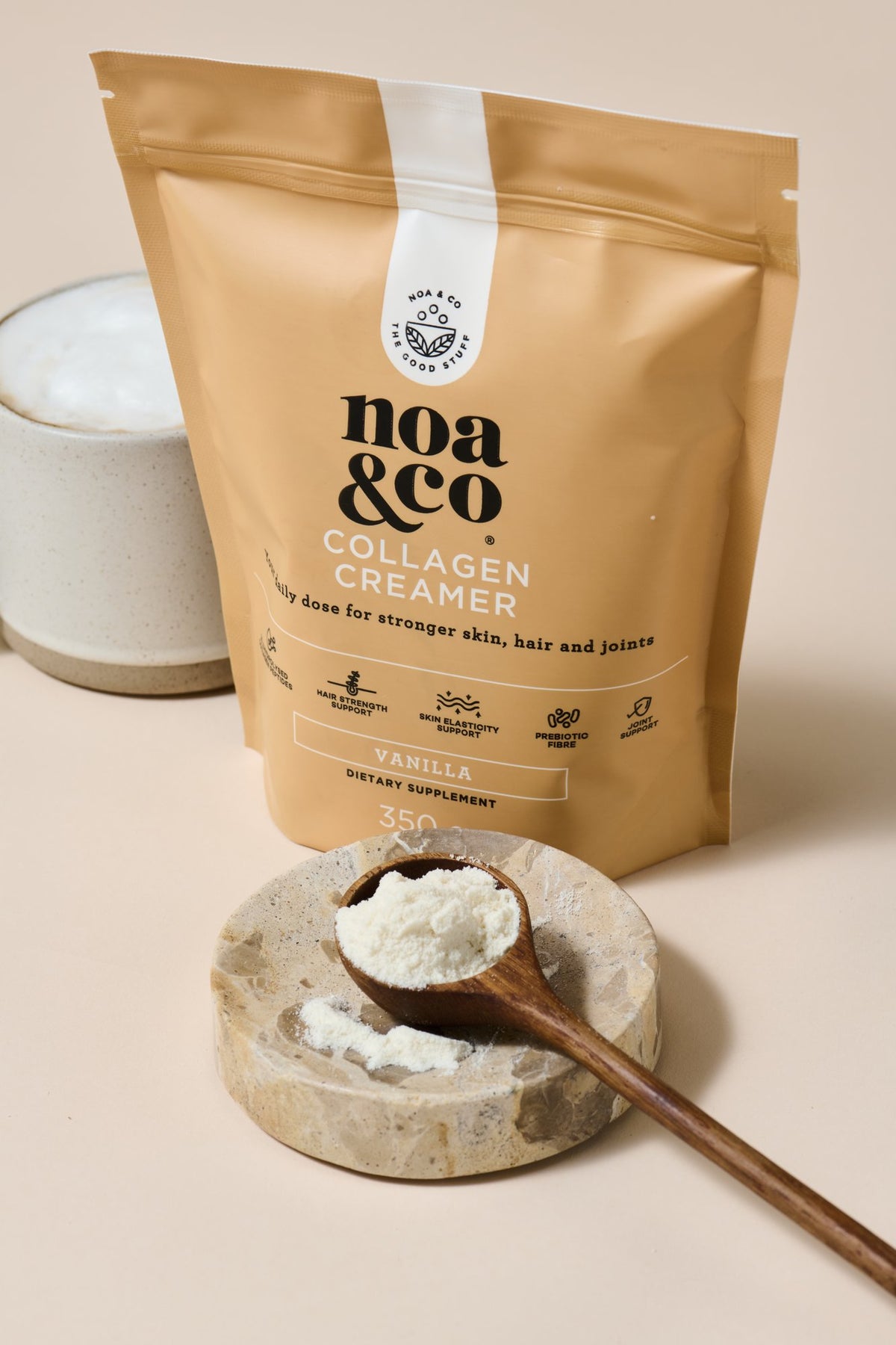 Collagen Creamer pouch with a scoop of powder and a mug
