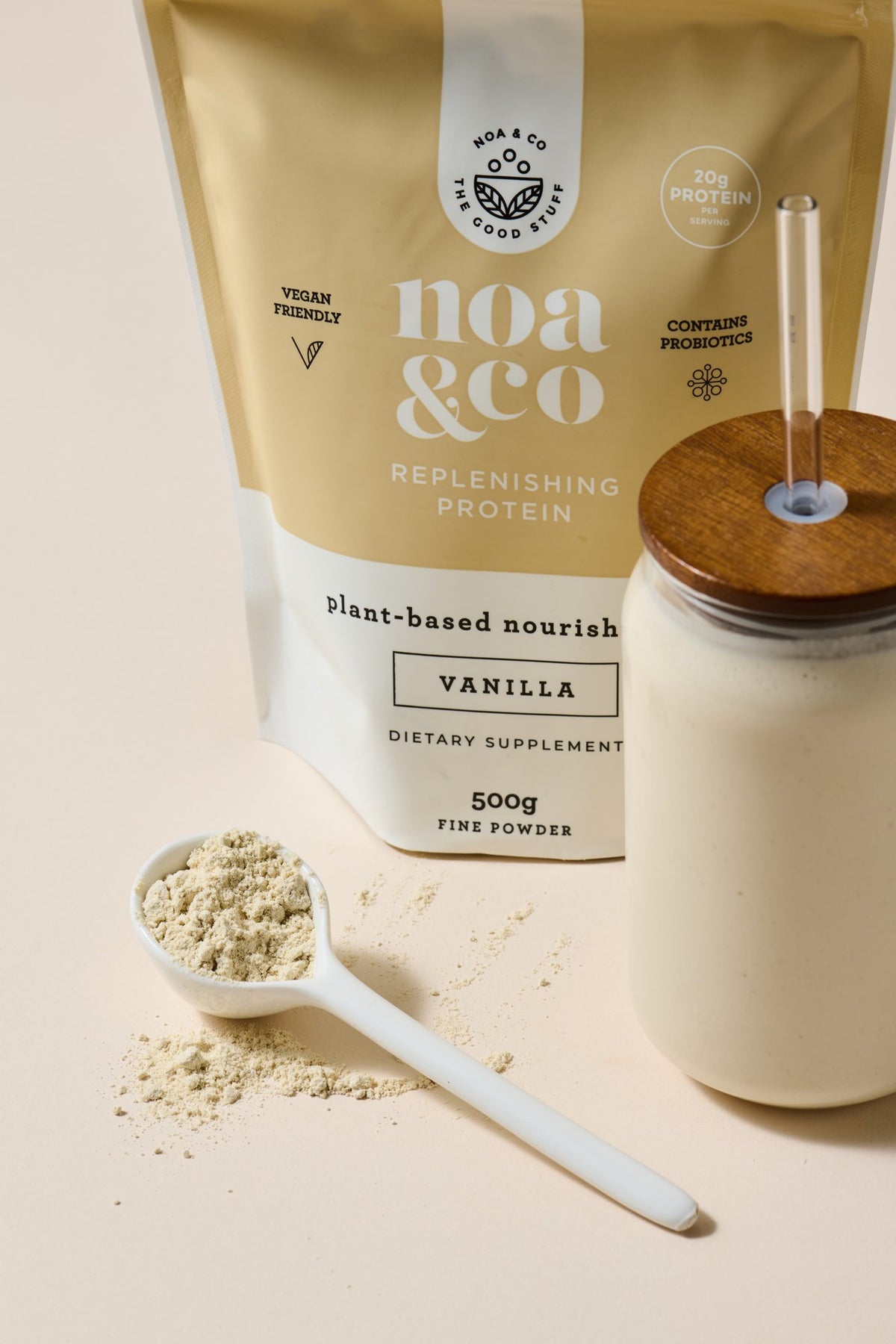 Vanilla Replenishing Protein pouch with a scoop and a smoothie