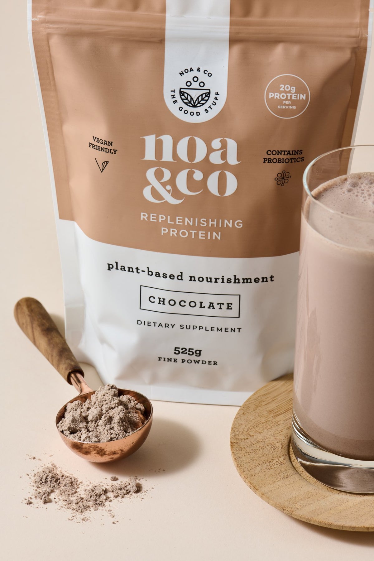 Chocolate Replenishing Protein pouch with a scoop and a chocolate shake