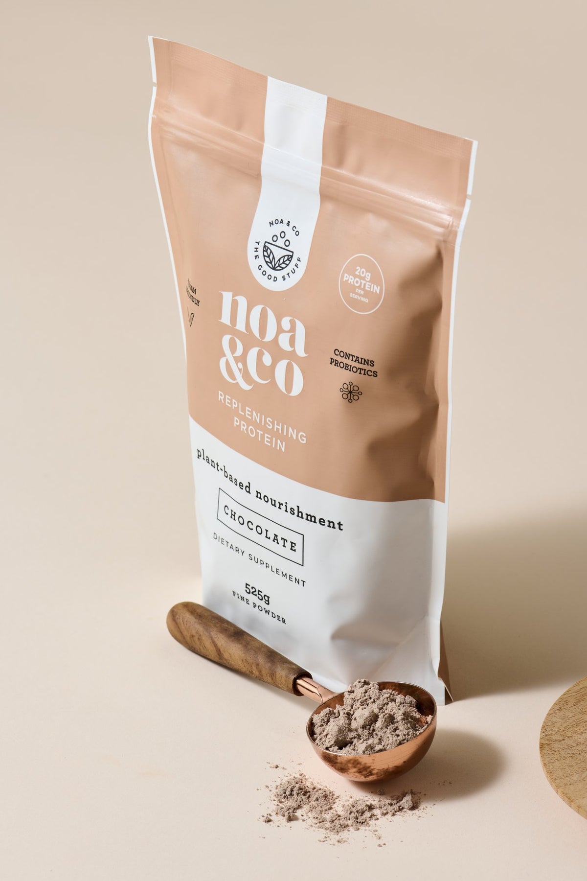 Chocolate Replenishing Protein pouch with a scoop of powder