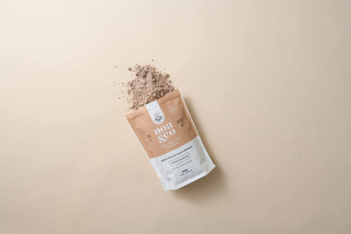 Chocolate Replenishing Protein pouch with powder spilling out